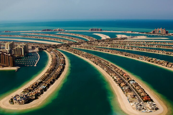 Soaring above the iconic Palm Jumeirah experience breathtaking views of luxurious villas and azure waters immersing yourself in Dubai's remarkable landscape from The Palm Tower's observation deck.